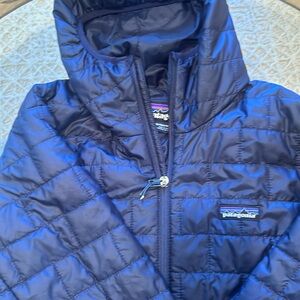 Size m hooded Nano puffer. Slight snag left arm. Zipper works short string pulll